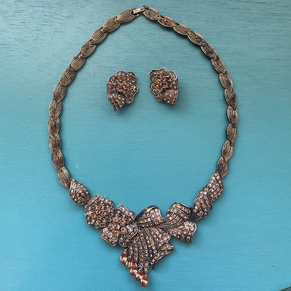 Statement necklace with clip on earrings, copper in color.